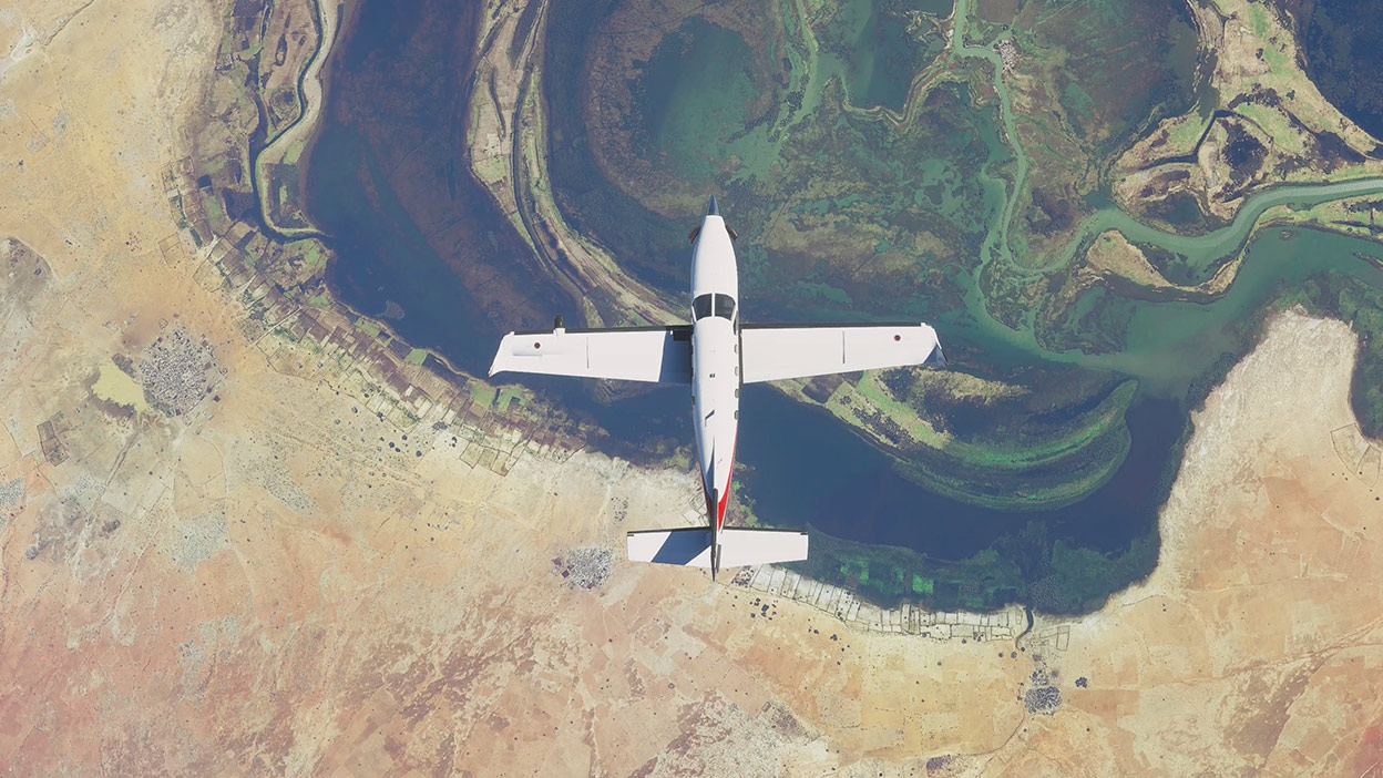 A Microsoft Flight Simulator repülőgépe szárazföld és víz felett repül
